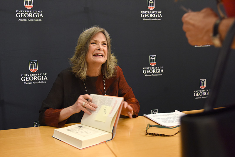 Delia Owens signing a copy of her book.