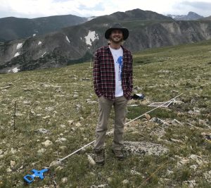 Riley Thoen in a mountainous area researching Porter's sunflowers