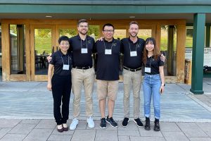 Taylor Martin standing with colleagues