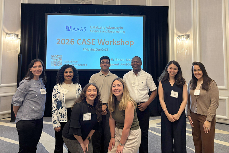 CASE 2026 participants posing together in front of a CASE Workshop display screen