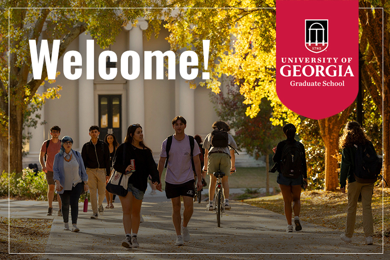 Welcome! Students walking and bicycling in front of Brooks Hall and the Graduate School.
