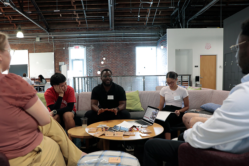 Kwaku Danso discussing his internship experience with a group of xPD showcase attendees