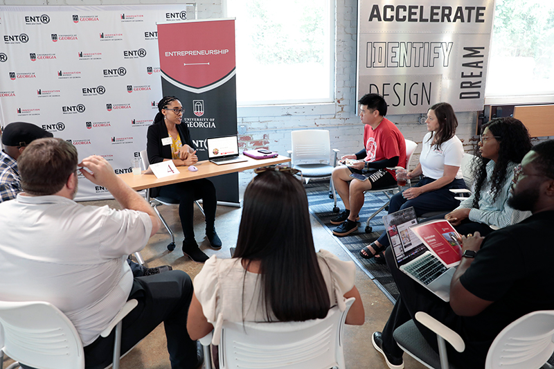 Group of xPD showcase participants discussing the summer internship